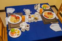 a blue table with plates of food on it at Randa Cottages Moshi in Kirua