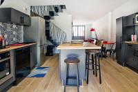 a kitchen with a island in the middle of a room at Le Pop in Saint-Julien-Chapteuil