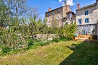 an old stone house with a garden in front of it at Le Pop in Saint-Julien-Chapteuil