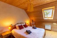 a bedroom with a bed in a wooden cabin at Ty Lann in Telgruc-sur-Mer
