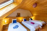 two beds in a room with a attic at Ty Lann in Telgruc-sur-Mer