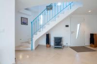 a living room with a staircase with blue rails at SERRENDY Calm family house with swimming pool in Antibes