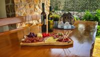 a tray of food and two glasses of wine on a table at Villa Prima Natura, Imotski private pool in Imotski