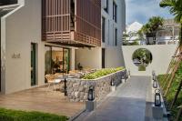 a patio with a table and chairs on a building at Maladee Rendezvous Hotel Chiang Mai in Chiang Mai