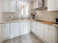 a white kitchen with white cabinets and a sink at Holiday Home with Roofed Swimming Pool in Villeneuve-sur-Lot