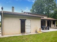 a small house with a door and a yard at Holiday Home with Roofed Swimming Pool in Villeneuve-sur-Lot