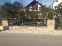 a brick fence in front of a house at kuća za odmor Anić in Pirovac