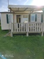 a mobile home with a porch and a deck at Camping du phare d opale p48 in Le Portel