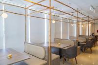 a dining room with wooden tables and chairs at Rosaleen Boutique Hotel in Hue