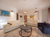 a living room with two couches and a table at Holiday Home Villa Orhidea by Interhome in (( Marčići ))