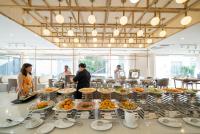 people are standing around a buffet of food at Rosaleen Boutique Hotel in Hue