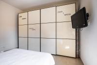 A television and/or entertainment centre at Bergonzoni Modern Apartment by Wonderful Italy