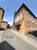 an old brick building with a man hole in the street at Appartement Oingt - Les Meublés des Pierres Dorées in Theizé