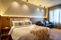 a hotel room with a bed and a chair at Jangal das Araucárias Swan Design Hotel Canela in Canela