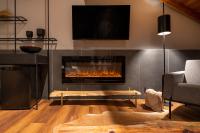 a living room with a fireplace with a tv at Jangal das Araucárias Swan Design Hotel Canela in Canela