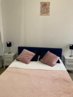a bed with two pink pillows on top of it at Charmant F4 proche de la gare Saint Charles in Marseille
