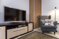 Televízia a/alebo spoločenská miestnosť v ubytovaní Apartament Tatry55
