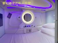 a room with a bed and a round mirror at Hey Bear Capsule Hotel in Taipei