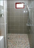 a shower with a glass door in a bathroom at La Tour Des Lys in Maubeuge