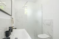 a white bathroom with a toilet and a sink at Mani in Pilkovići - Istrien in Kanfanar