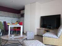 a living room with a table and chairs and a television at Appartement La Rochelle, 3 pièces, 4 personnes - FR-1-246-588 in La Rochelle