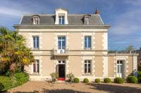 a large house with a palm tree in front of it at Le Pavillon des Lys - Hôtel Particulier in Amboise