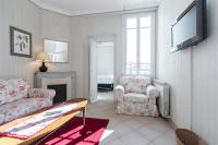 a living room with a couch and a tv at Three bedroom two bathroom apartment in center of Cannes on quiet street minutes from the Palais - 2002 in Cannes