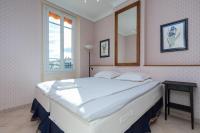 a large white bed in a room with a mirror at Three bedroom two bathroom apartment in center of Cannes on quiet street minutes from the Palais - 2002 in Cannes