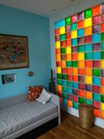 a room with a couch and a colorful wall at Le Palmier, Maison de ville, 3 chambres et jardin&#47;terrasse in Blois