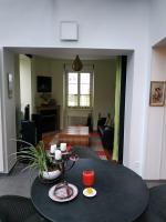 a living room with a table and a living room at Le Palmier, Maison de ville, 3 chambres et jardin&#47;terrasse in Blois