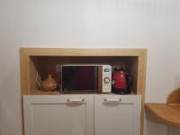 a microwave oven sitting on top of a cabinet at APPARTEMENT AVEC BALCON ENTRE PARIS ET DISNEY in Torcy