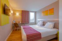 a hotel room with a large bed and a desk at Kyriad Lyon Est - Saint Bonnet De Mure in Saint-Bonnet-de-Mure