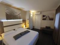 A bed or beds in a room at Therra Lodge