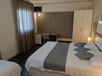 A bed or beds in a room at Therra Lodge