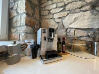 a coffee maker on a counter next to a stone wall at VILLA BERTO in Nedeščina