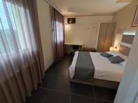 A bed or beds in a room at Therra Lodge