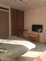 a bedroom with a bed and a flat screen tv at studio centre ville Agen in Agen