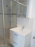a white bathroom with a sink and a shower at studio centre ville Agen in Agen