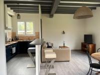 a kitchen and living room with a couch and a table at T3 Linxe océan et nature in Linxe
