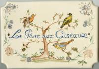 a plate with three birds sitting on a tree at Le Parc aux Oiseaux in Le Mesnil-Simon