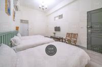 two beds in a room with white walls at 花蓮發現民宿-無人民宿自助入住-包棟可烤肉可麻將 in Hualien City