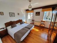 A bed or beds in a room at Hostal Giadás