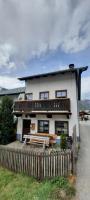 a white house with a fence in front of it at Maridl`s Ferienhaus in Umhausen