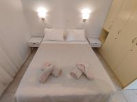 A bed or beds in a room at Glyfada Beach House