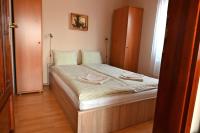 A bed or beds in a room at Liszkai Apartman