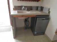 a kitchen counter with a sink and a dishwasher at Appartement entier T4 à Jausiers in Jausiers