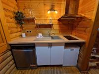 a kitchen with a sink and a stove at Les Chalets Amneville in Amnéville