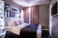 a hotel room with a bed and a window at Hotel Marais Grands Boulevards in Paris