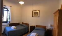 A bed or beds in a room at Agriturismo Diffuso Monte Oliveto Maggiore