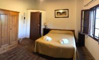 A bed or beds in a room at Agriturismo Diffuso Monte Oliveto Maggiore